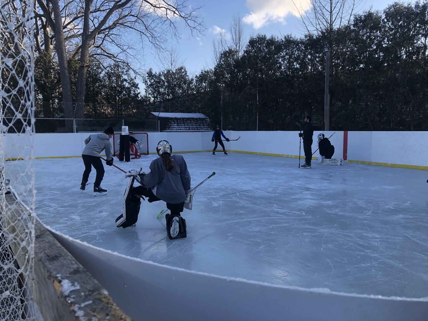 An open skate underway, players spread across the full sheet